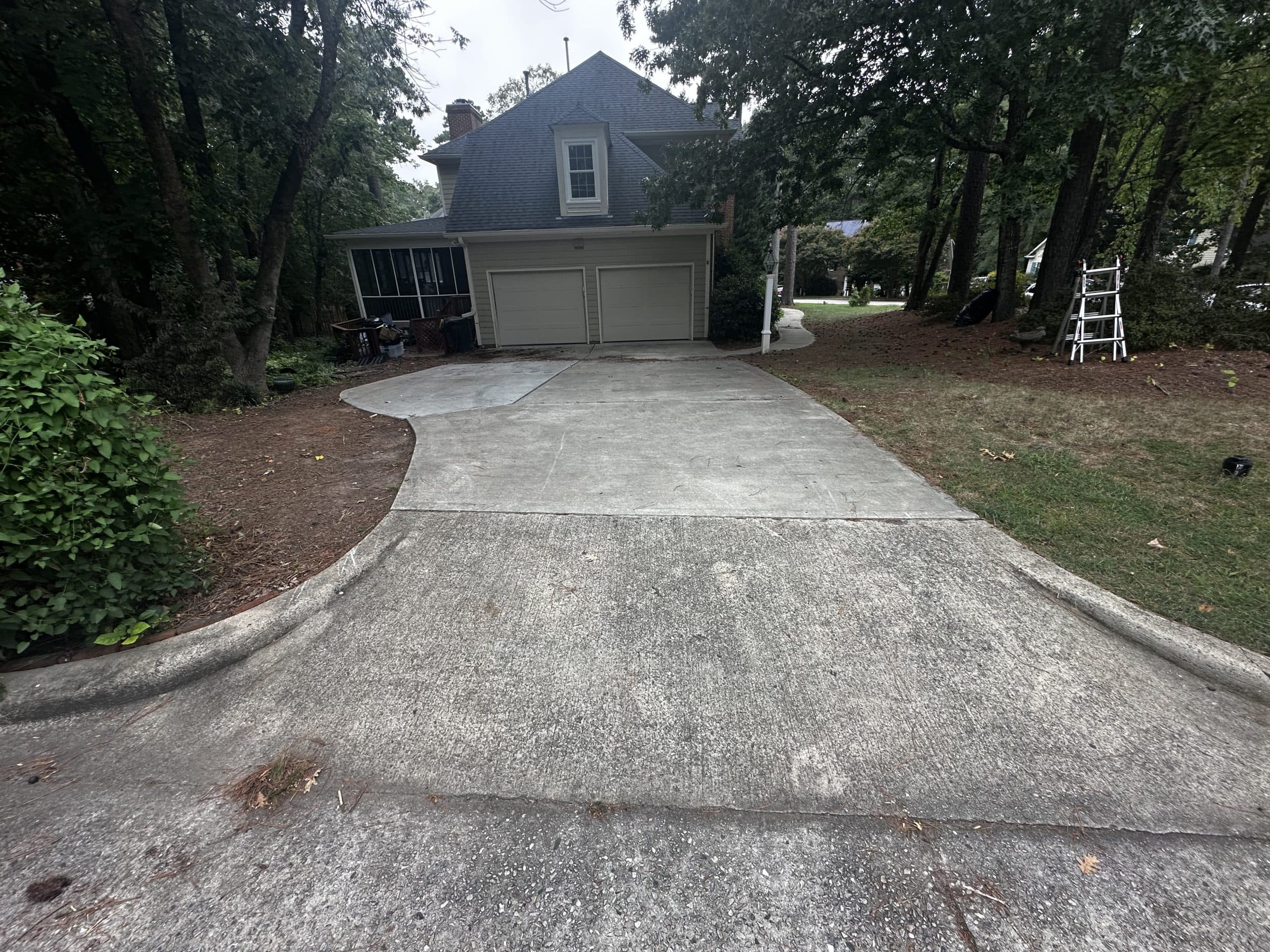 Gray, soiled concrete driveway before cleaning