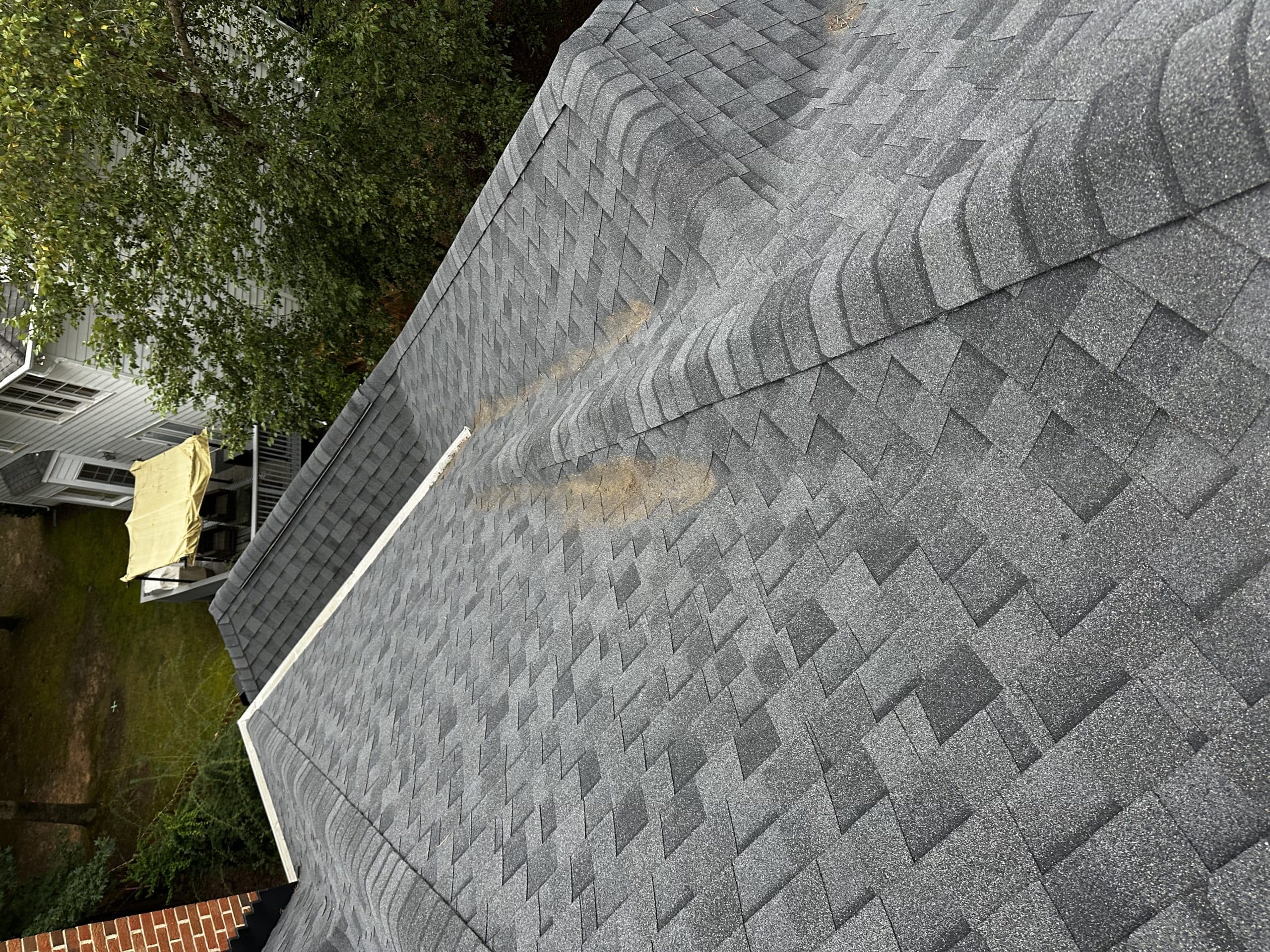 Same shingle roof after the debris was cleared